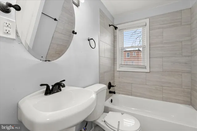 a bathroom with a sink a toilet and a bathtub