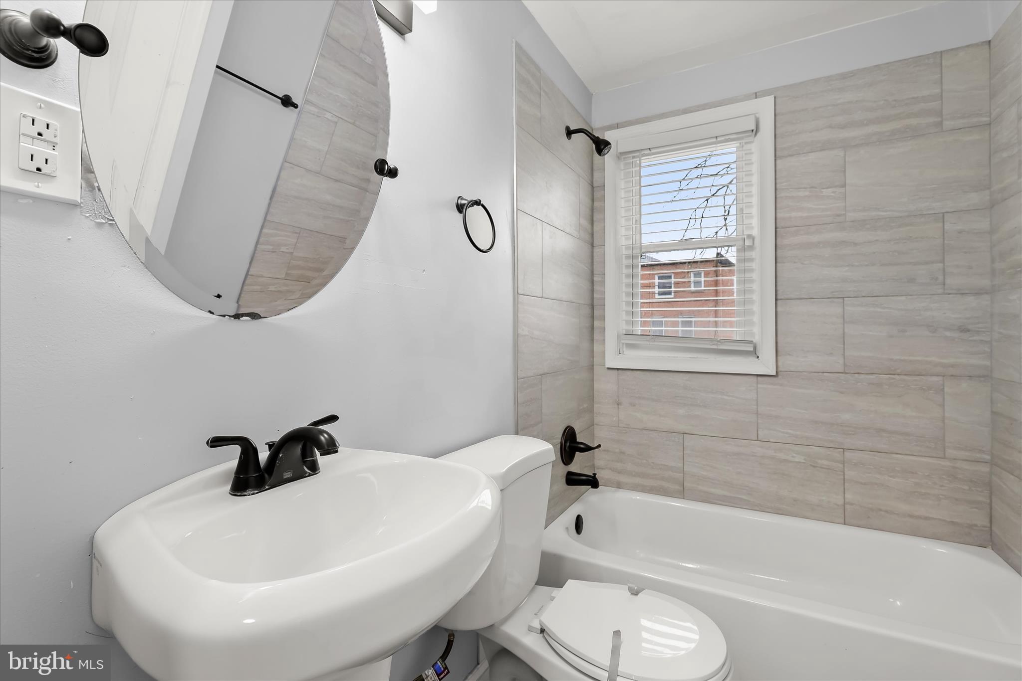 4352 Eldone Road Baltimore, MD 21229 - Photo 17 of 27 a bathroom with a sink a toilet and a bathtub