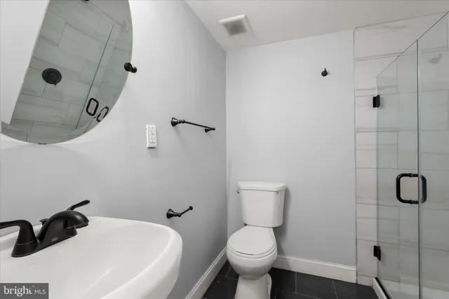 a bathroom with a toilet and a shower