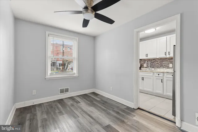 an empty room with a bathroom and a window