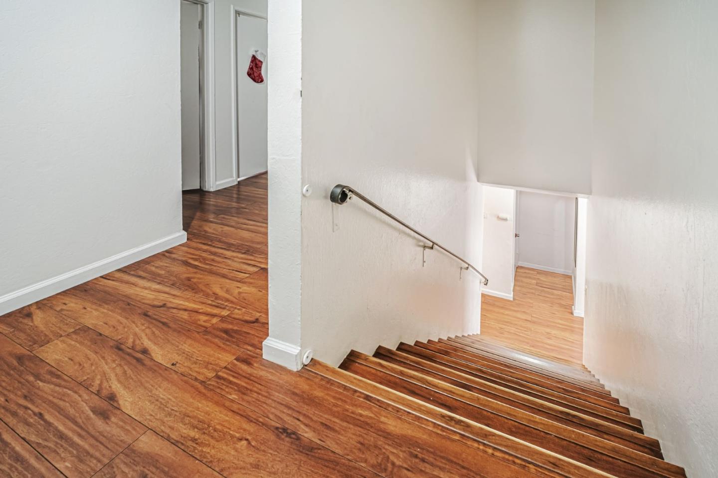 188 Sunset Boulevard Hayward, CA 94541 - Photo 5 of 15 a view of a hallway with wooden floor and staircase