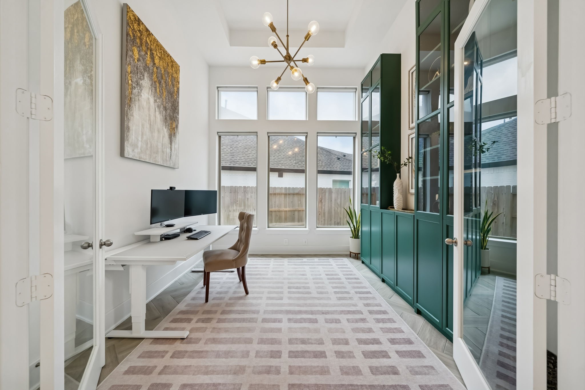 519 Caverna Street Montgomery, TX 77316 - Photo 15 of 41 Private study with French doors and tall windows, featuring color-drenched cabinetry that adds both character and functional storage.