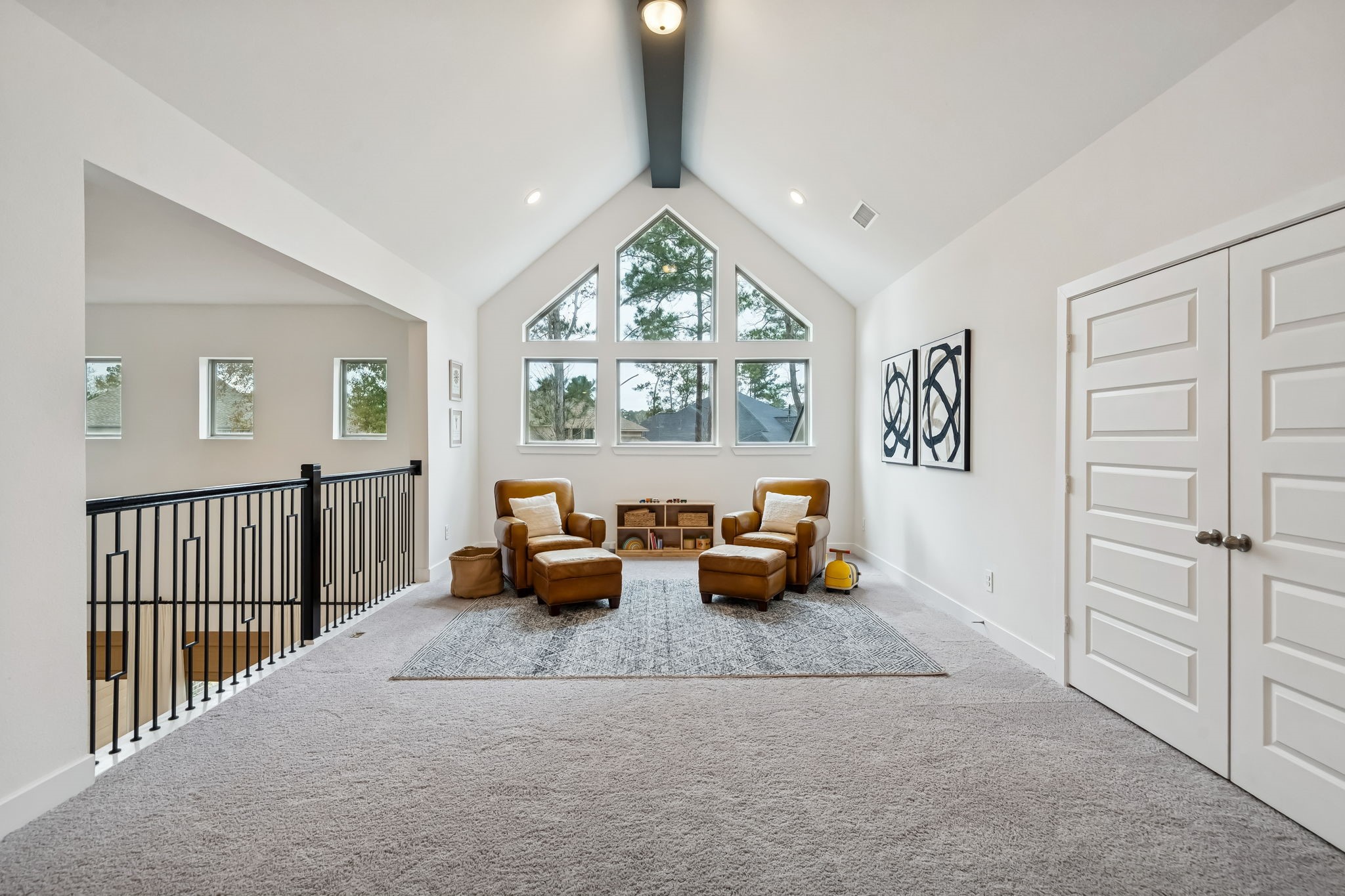 519 Caverna Street Montgomery, TX 77316 - Photo 24 of 41 Generous 14’ x 20’ upstairs game room with vaulted ceiling and large windows, creating a bright and flexible second living space.