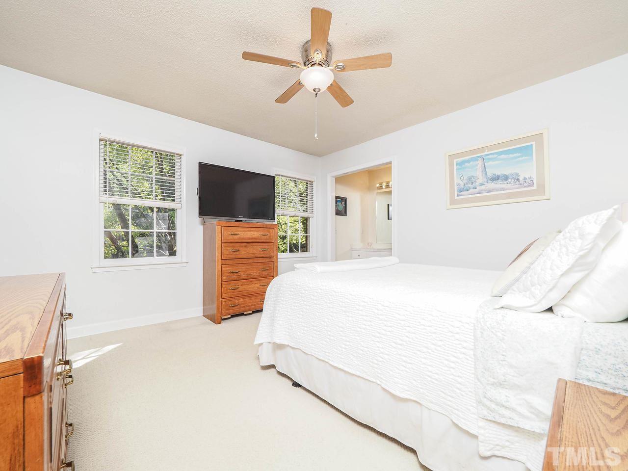 3134 Morningside Drive Raleigh, NC 27607 - Photo 13 of 22 a bedroom with a bed and a flat screen tv