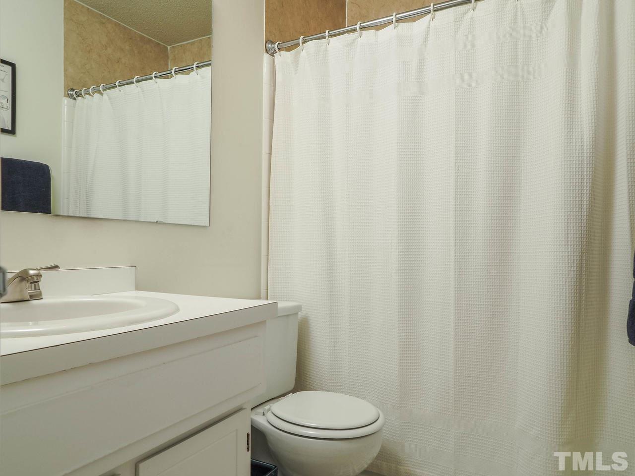 3134 Morningside Drive Raleigh, NC 27607 - Photo 17 of 22 a bathroom with a sink a toilet and shower curtain
