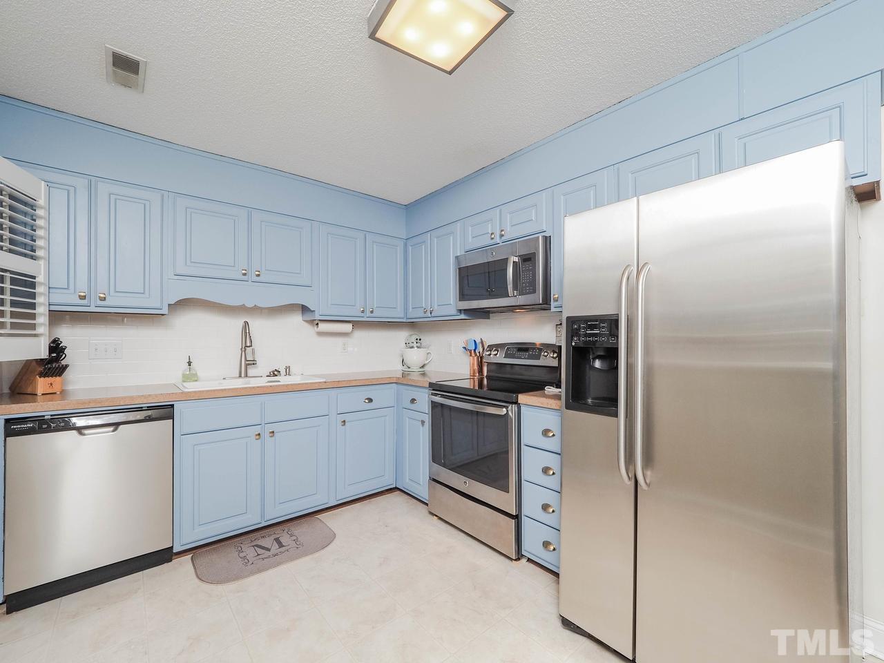 3134 Morningside Drive Raleigh, NC 27607 - Photo 4 of 22 a kitchen with cabinets stainless steel appliances and a window