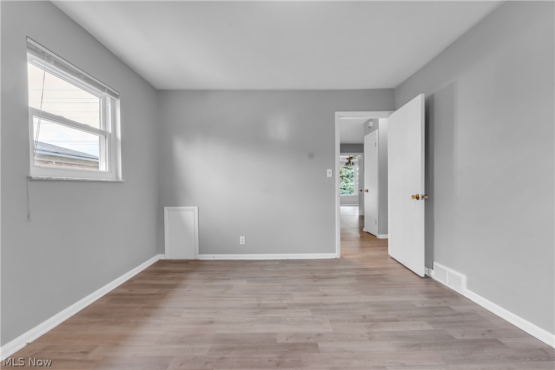 2915 Snow Road, Unit 2/UP Cleveland, OH 44134 - Photo 13 of 23 Interior room featuring wood-finish flooring, light gray wall paint, and white baseboards