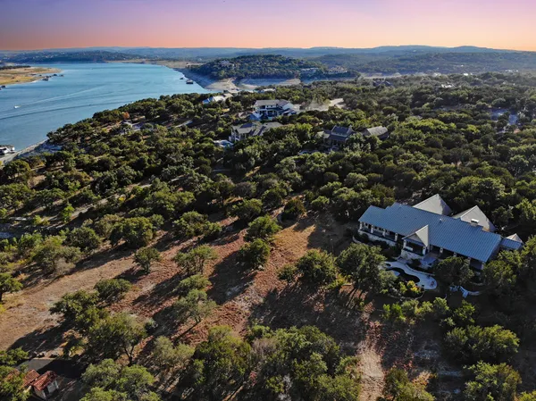 an aerial view of house with yard and mountain view in back