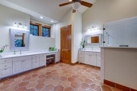 a large bathroom with a sink a vanity and a mirror