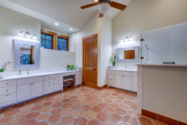 a large bathroom with a sink a vanity and a mirror