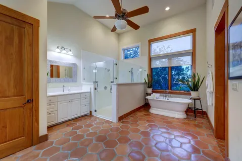 a large bathroom with a bathtub and a sink