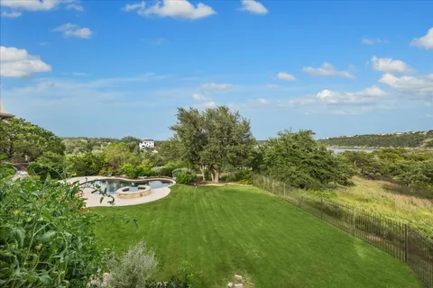 a view of a patio with table and chairs potted plants with floor to ceiling window