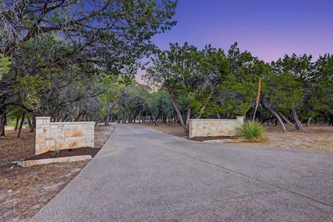 a view of a street with a tree in the background