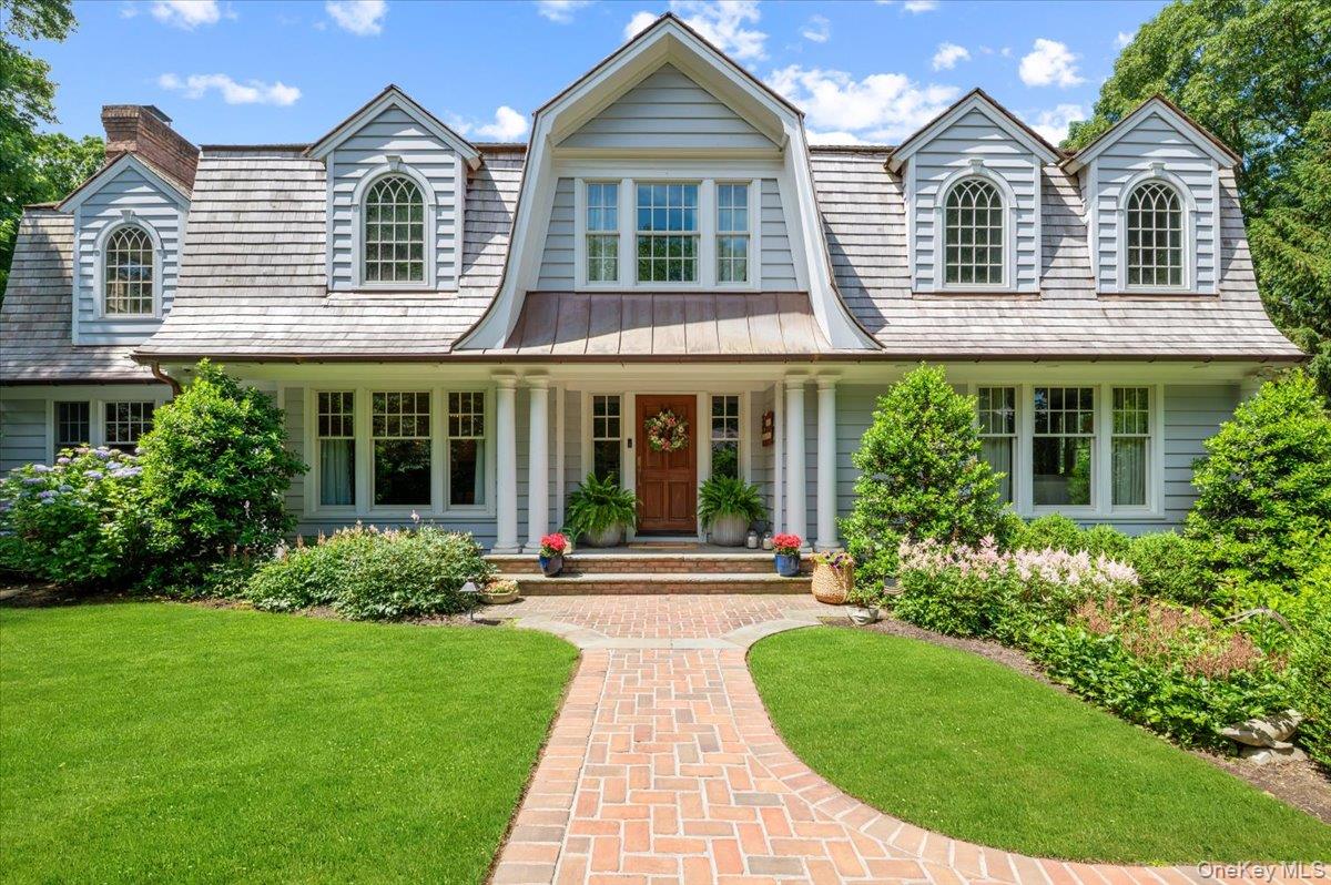 5 Fox Hunt Court Cold Spring Harbor, NY 11724 - Photo 2 of 42 Shingle-style residence featuring a prominent gambrel roofline and two arched dormer windows