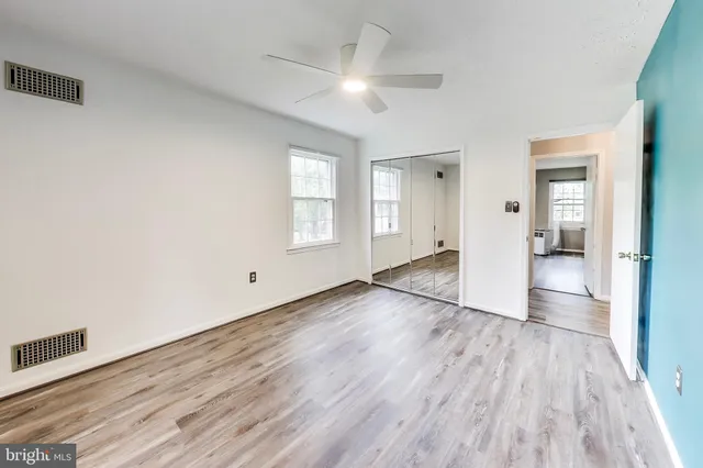 wooden floor in an empty room with a window