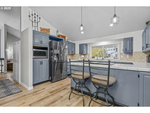 a kitchen with appliances cabinets and a counter top space