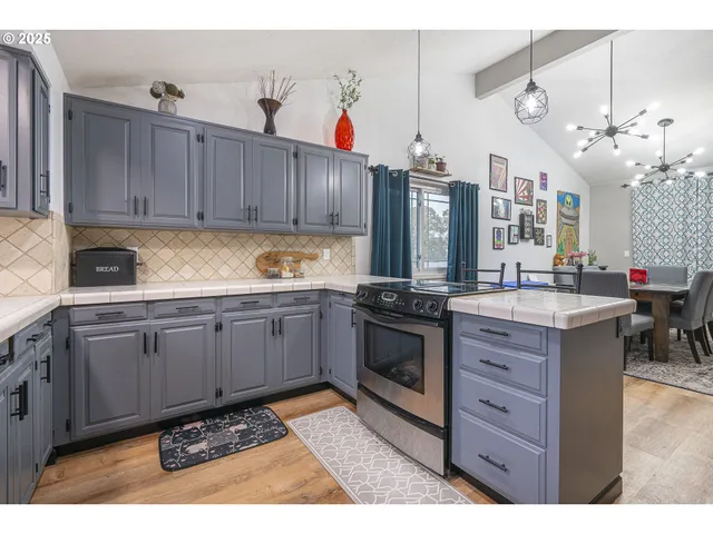 a kitchen with appliances cabinets and a counter top space