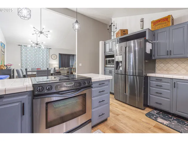 a view of a dining room with furniture and chandelier