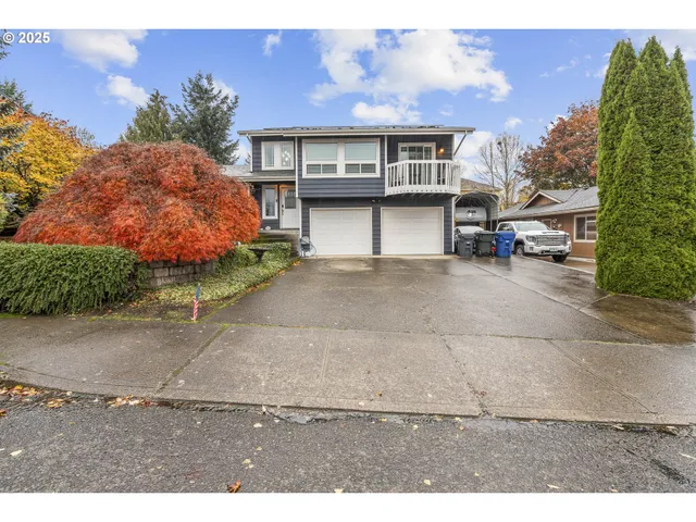 a view of a house with a garden and pathway