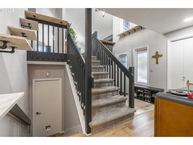 a view of entryway and hall with wooden floor