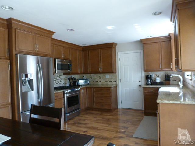 2239 Ralston Street Simi Valley, CA 93063 - Photo 14 of 29 a kitchen with granite countertop a refrigerator stove and sink