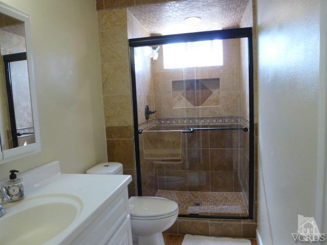 2239 Ralston Street Simi Valley, CA 93063 - Photo 23 of 29 a bathroom with a shower a toilet and a sink