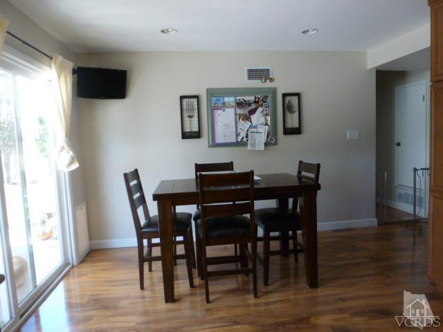 2239 Ralston Street Simi Valley, CA 93063 - Photo 8 of 29 a view of a dining room with furniture and wooden floor