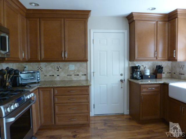 2239 Ralston Street Simi Valley, CA 93063 - Photo 10 of 29 a kitchen with granite countertop wooden cabinets and a stove top oven