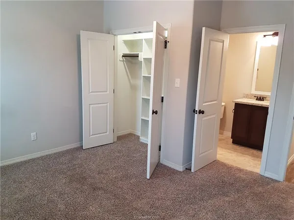 a white toilet sitting next to a bathtub