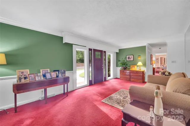 a bedroom with furniture and a large window