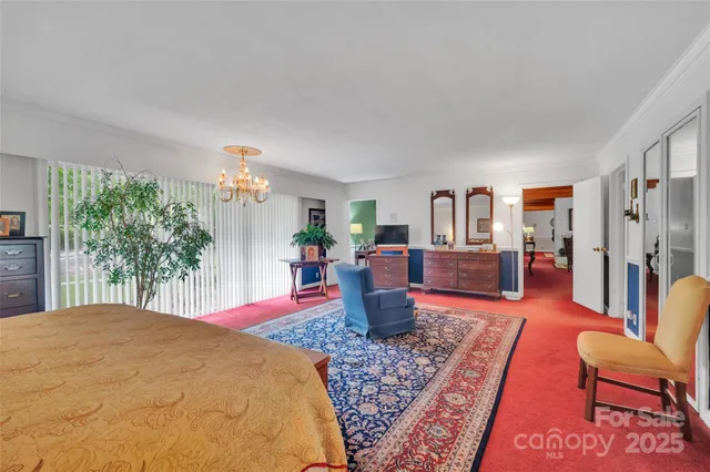 a bedroom with furniture and a rug