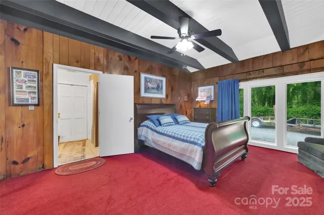 a bedroom with a bed next to a window