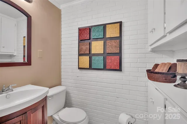 a patio with table and chairs and potted plants