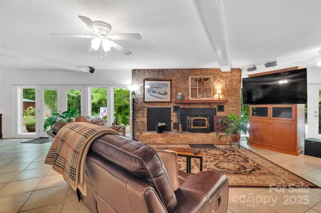 a living room with fireplace furniture and a flat screen tv