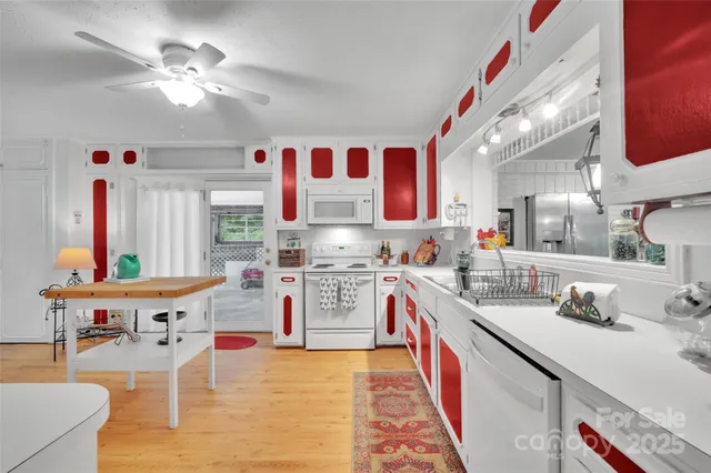 a kitchen with stainless steel appliances kitchen island granite countertop a sink and cabinets