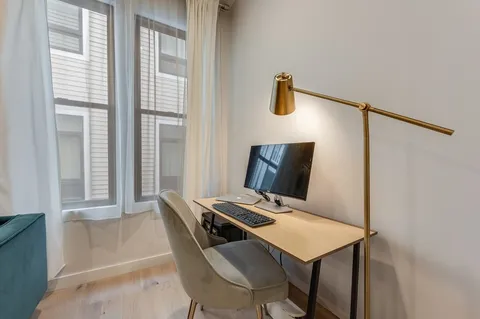 a view of a dining room with furniture and a window