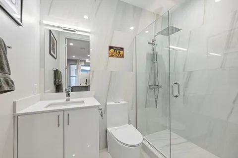 a bathroom with a toilet a sink and shower