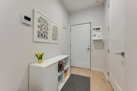 a view of hallway with paintings on the wall