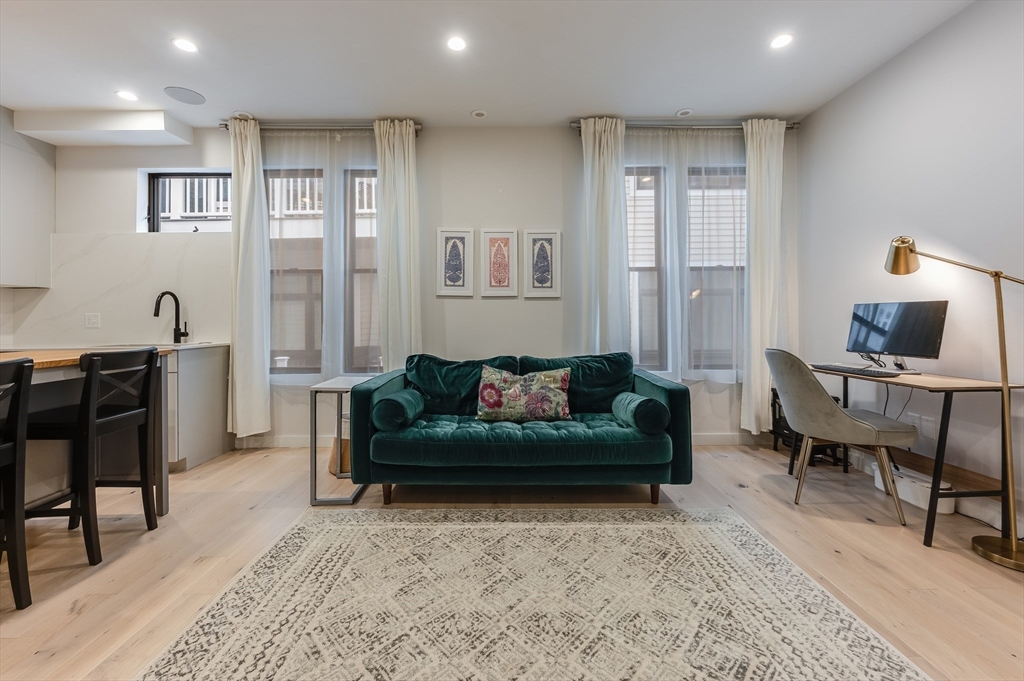 340 West 2nd Street, Unit 5 Boston, MA 02127 - Photo 2 of 25 a living room with furniture and a table