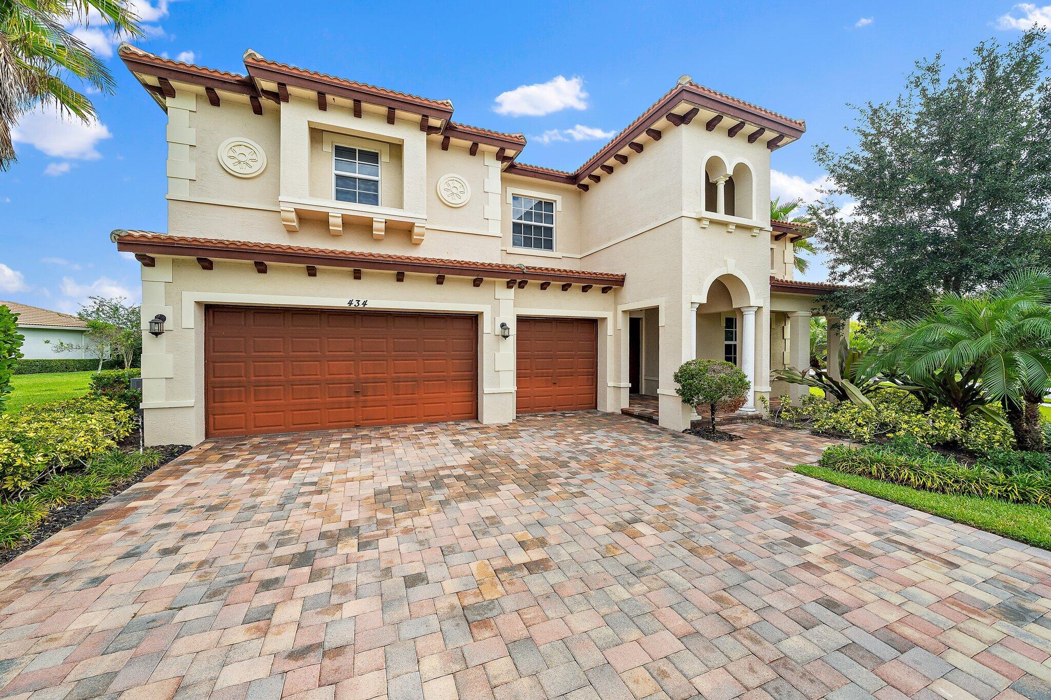 434 Rudder Cay Way Jupiter, FL 33458 - Photo 1 of 52 a front view of a house with a yard and garage