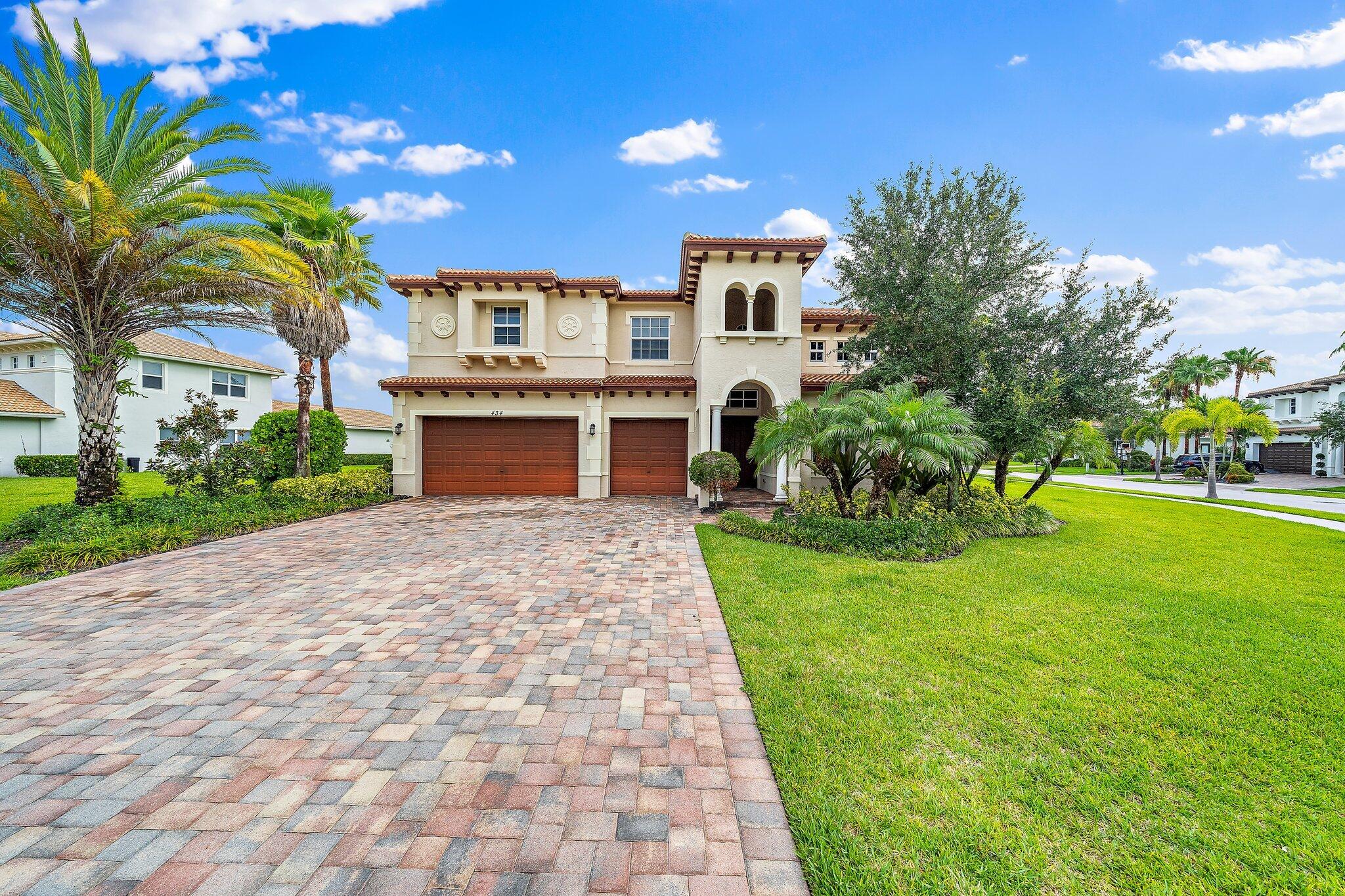 434 Rudder Cay Way Jupiter, FL 33458 - Photo 2 of 52 a front view of a house with a garden and yard