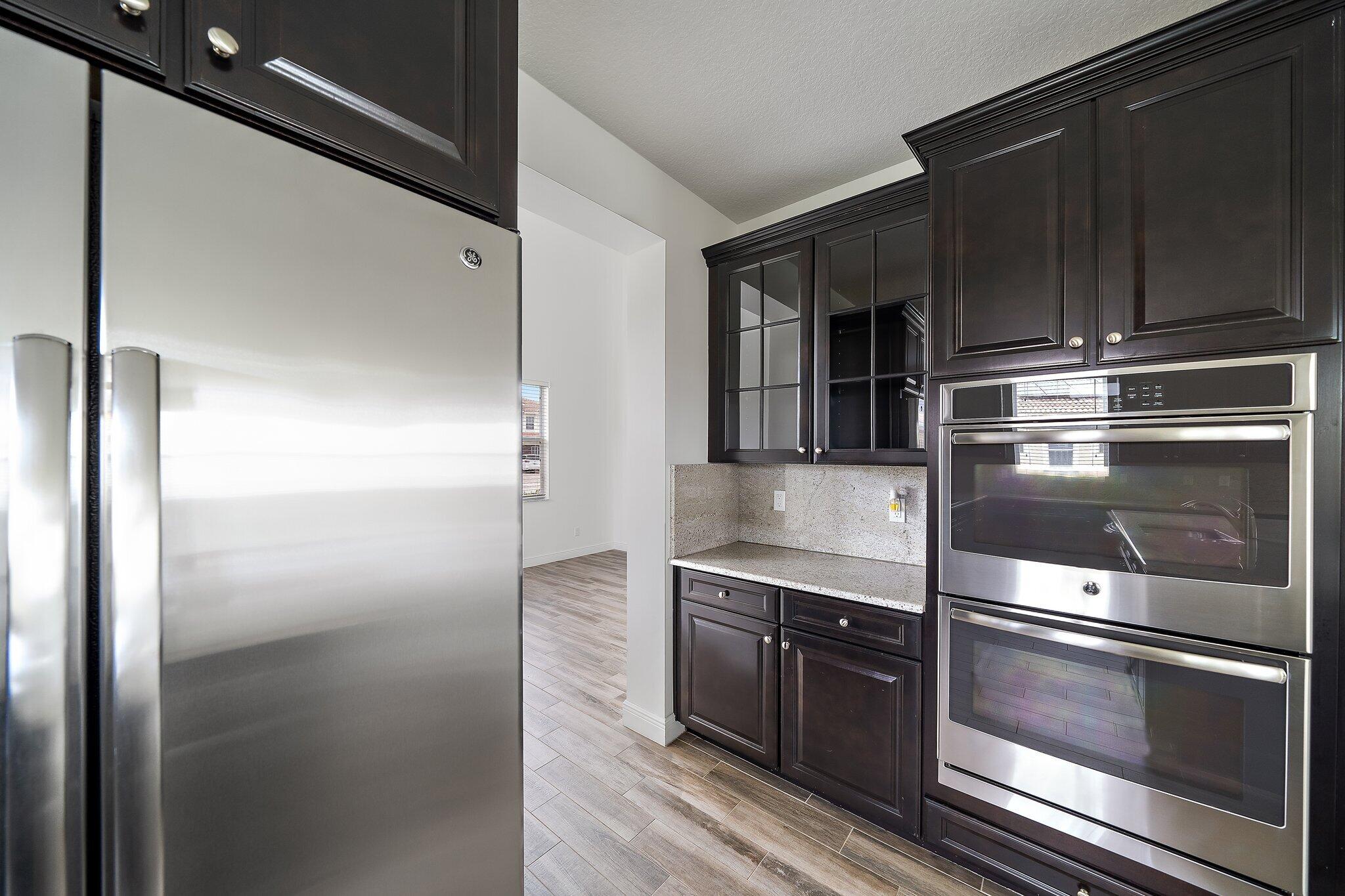 434 Rudder Cay Way Jupiter, FL 33458 - Photo 12 of 52 a kitchen with a refrigerator stove and cabinets