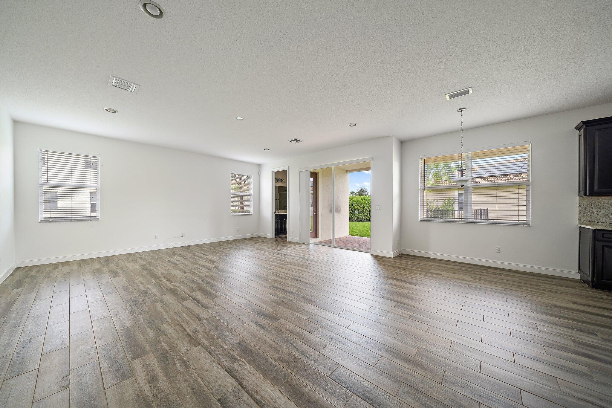 434 Rudder Cay Way Jupiter, FL 33458 - Photo 15 of 52 an empty room with wooden floor and windows