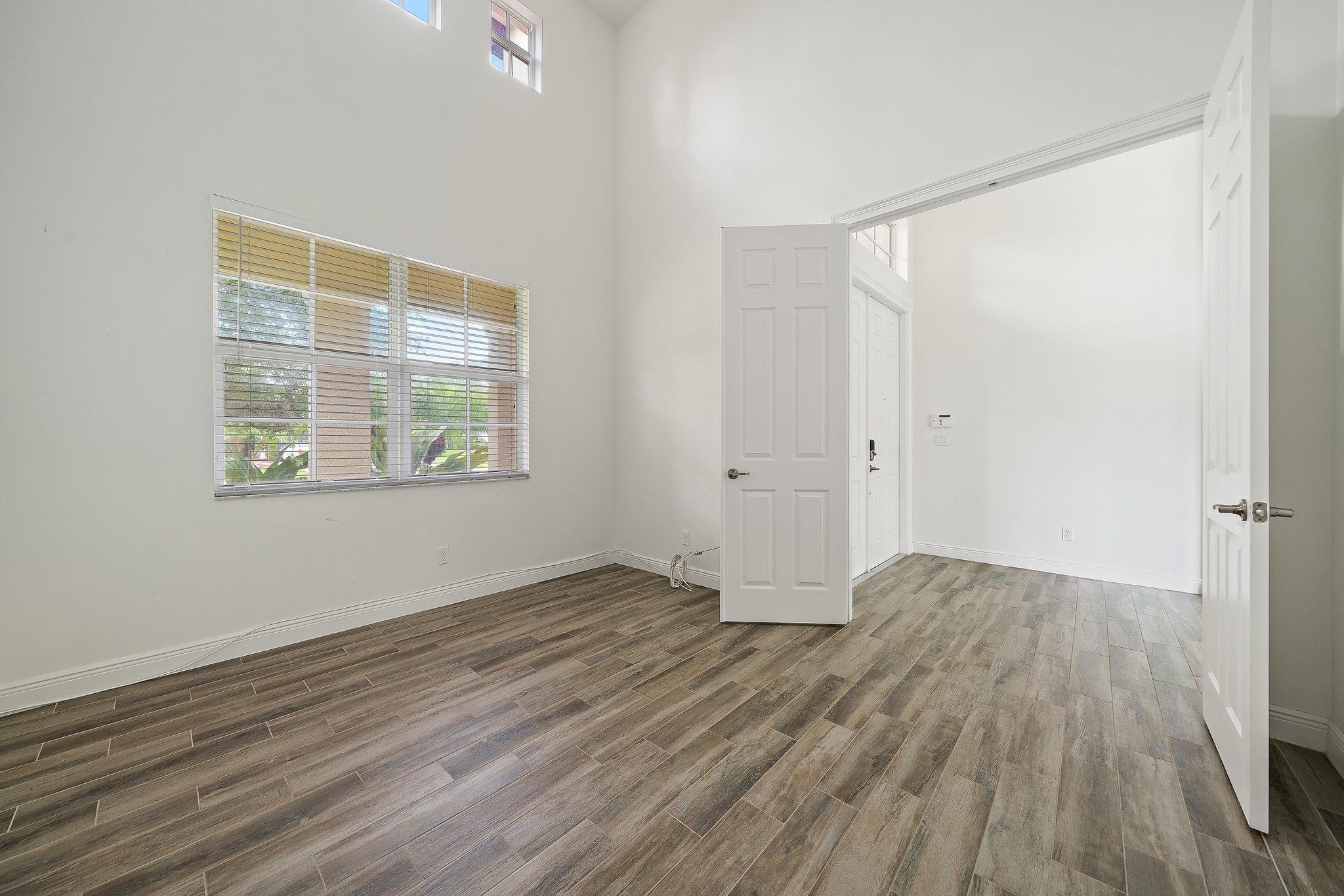 434 Rudder Cay Way Jupiter, FL 33458 - Photo 20 of 52 a view of an empty room with wooden floor and a window