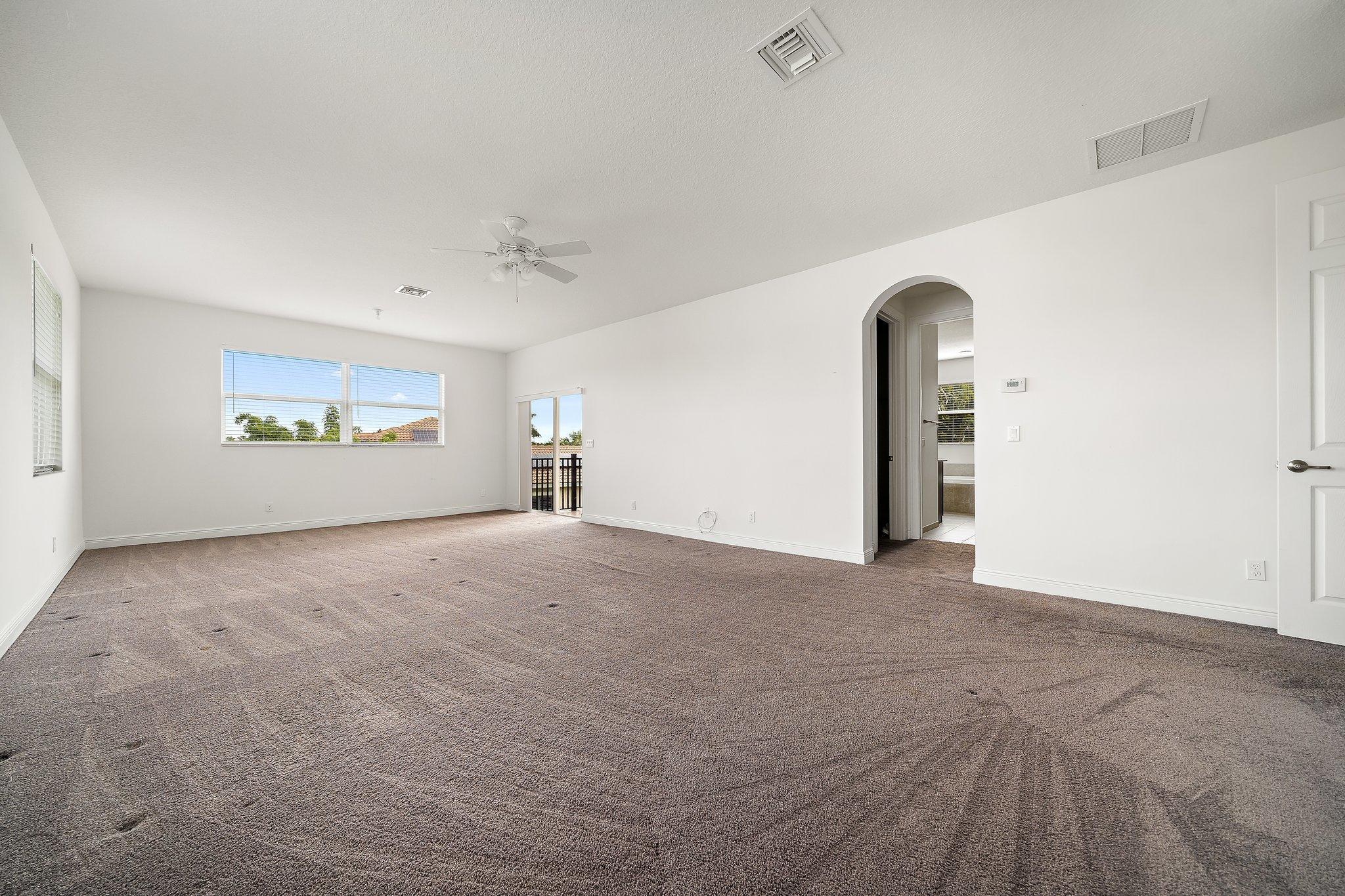 434 Rudder Cay Way Jupiter, FL 33458 - Photo 27 of 52 an empty room with windows and mirror