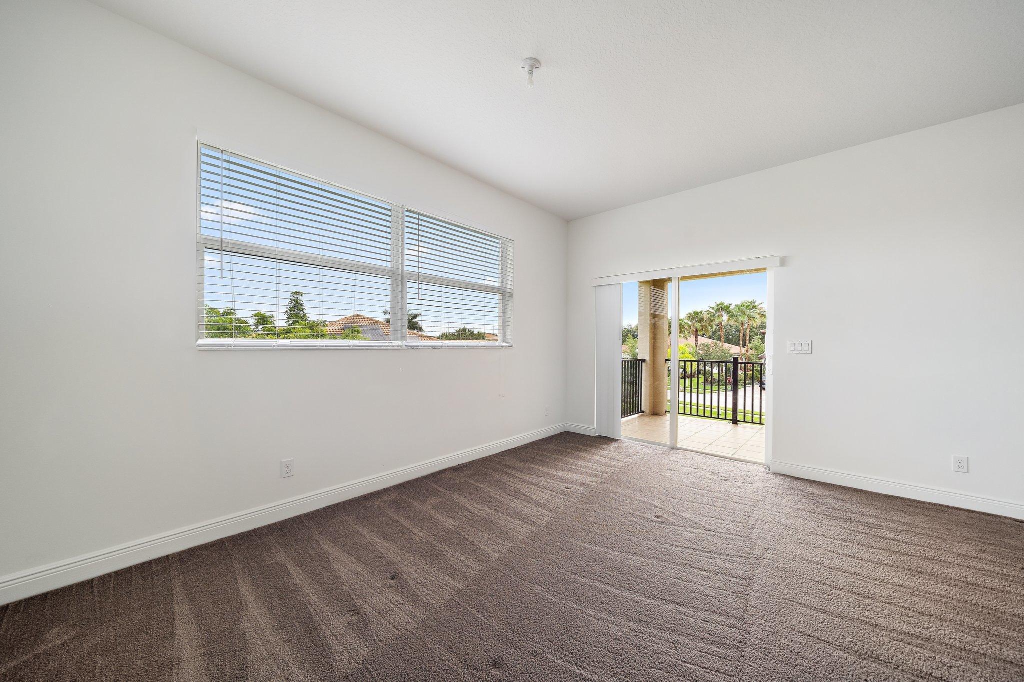 434 Rudder Cay Way Jupiter, FL 33458 - Photo 29 of 52 an empty room with wooden floor and windows