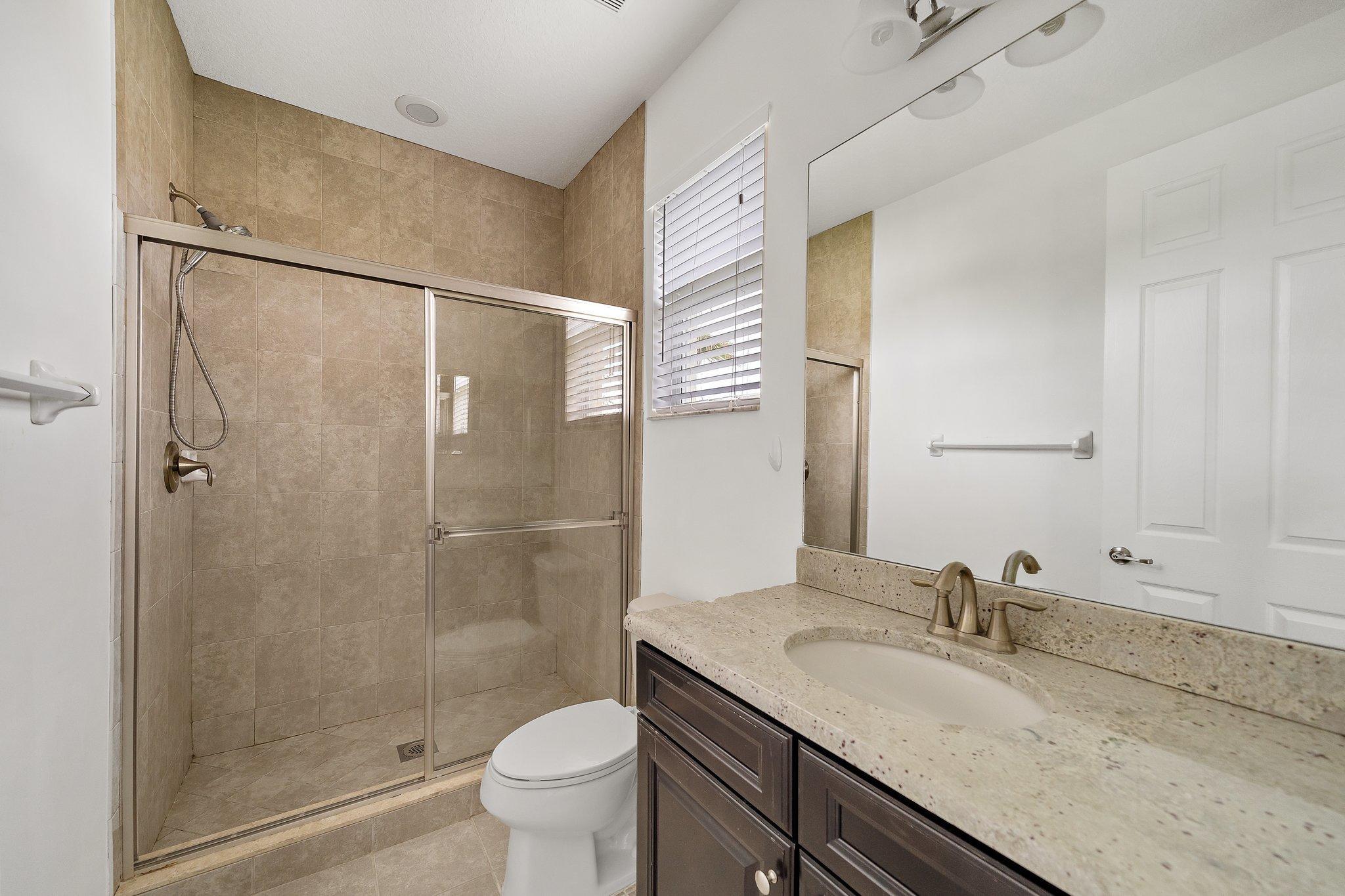 434 Rudder Cay Way Jupiter, FL 33458 - Photo 36 of 52 a bathroom with a granite countertop sink toilet and shower