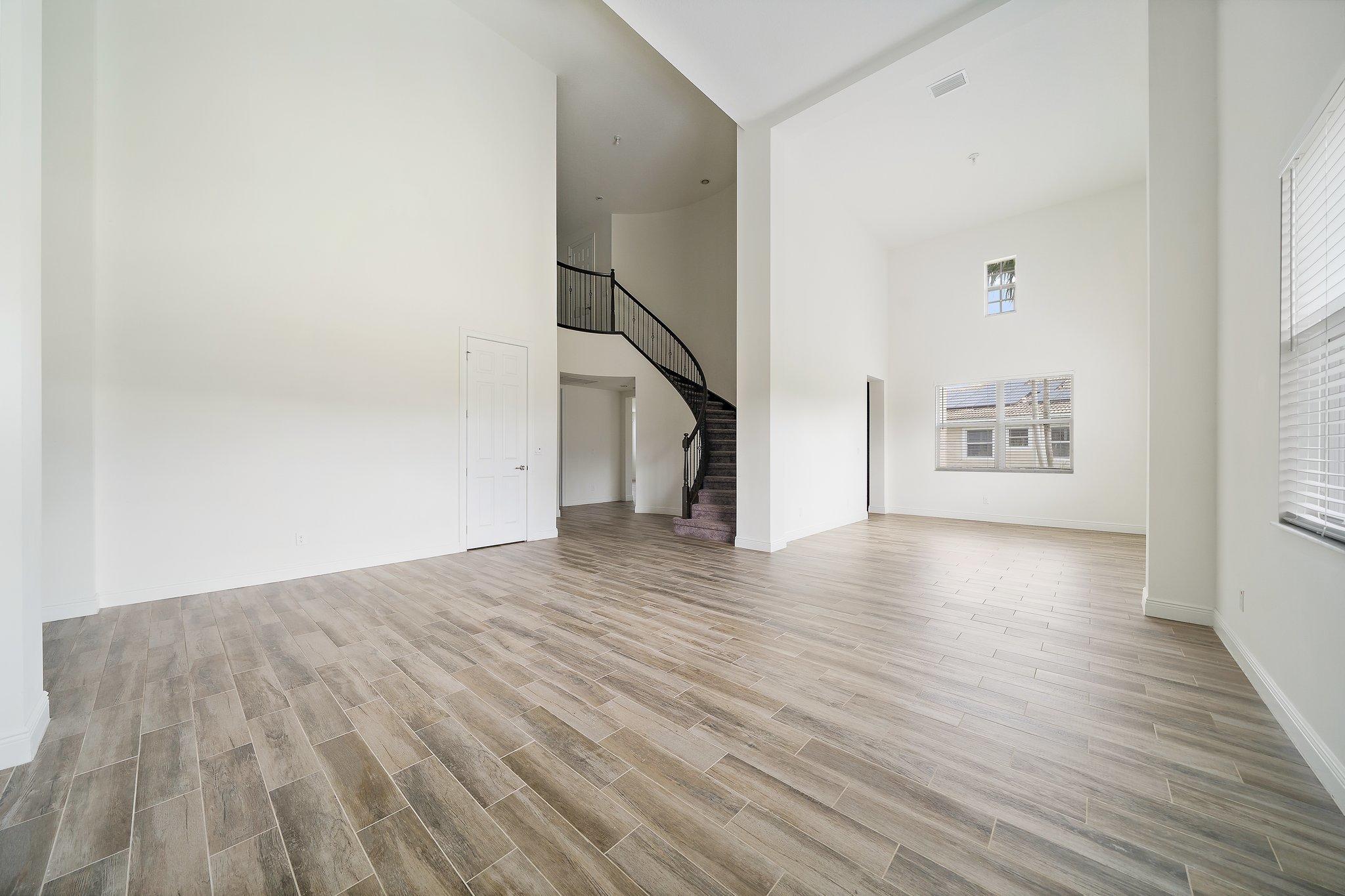434 Rudder Cay Way Jupiter, FL 33458 - Photo 6 of 52 a view of an empty room with wooden floor and a window