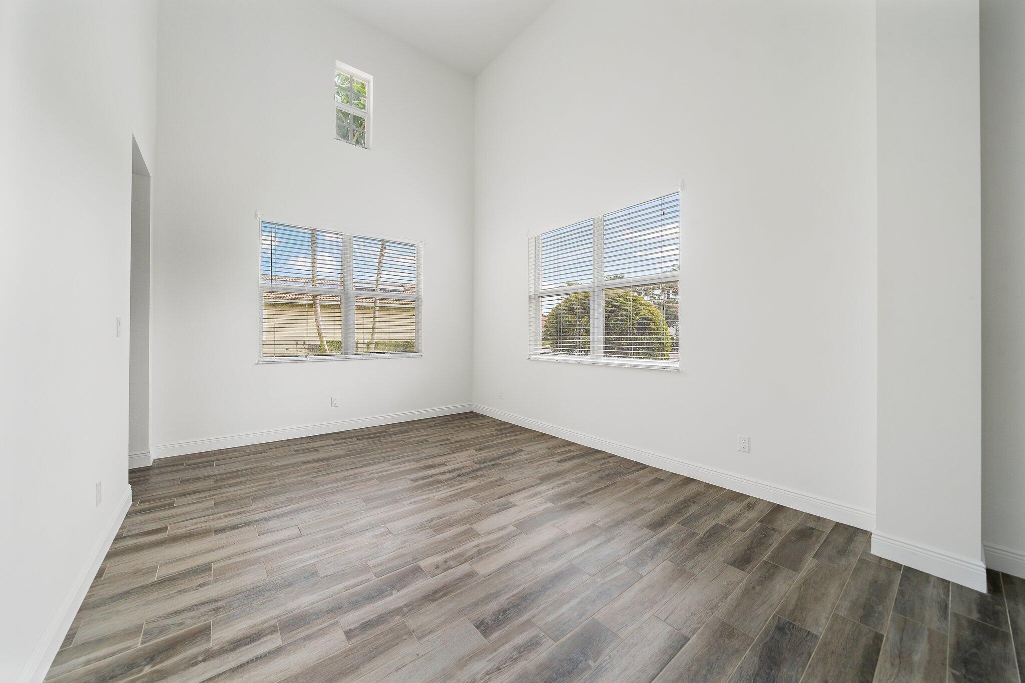 434 Rudder Cay Way Jupiter, FL 33458 - Photo 7 of 52 an empty room with wooden floor and windows
