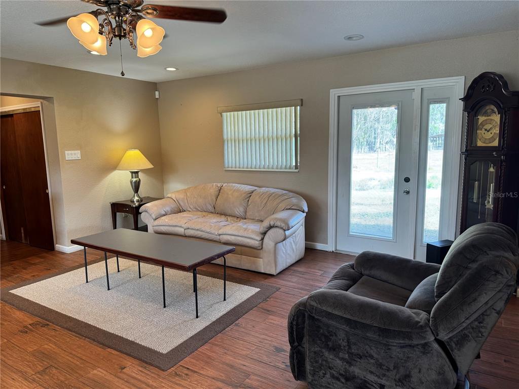 5333 Deeson Road Lakeland, FL 33810 - Photo 13 of 44 a living room with furniture a lamp and a chandelier